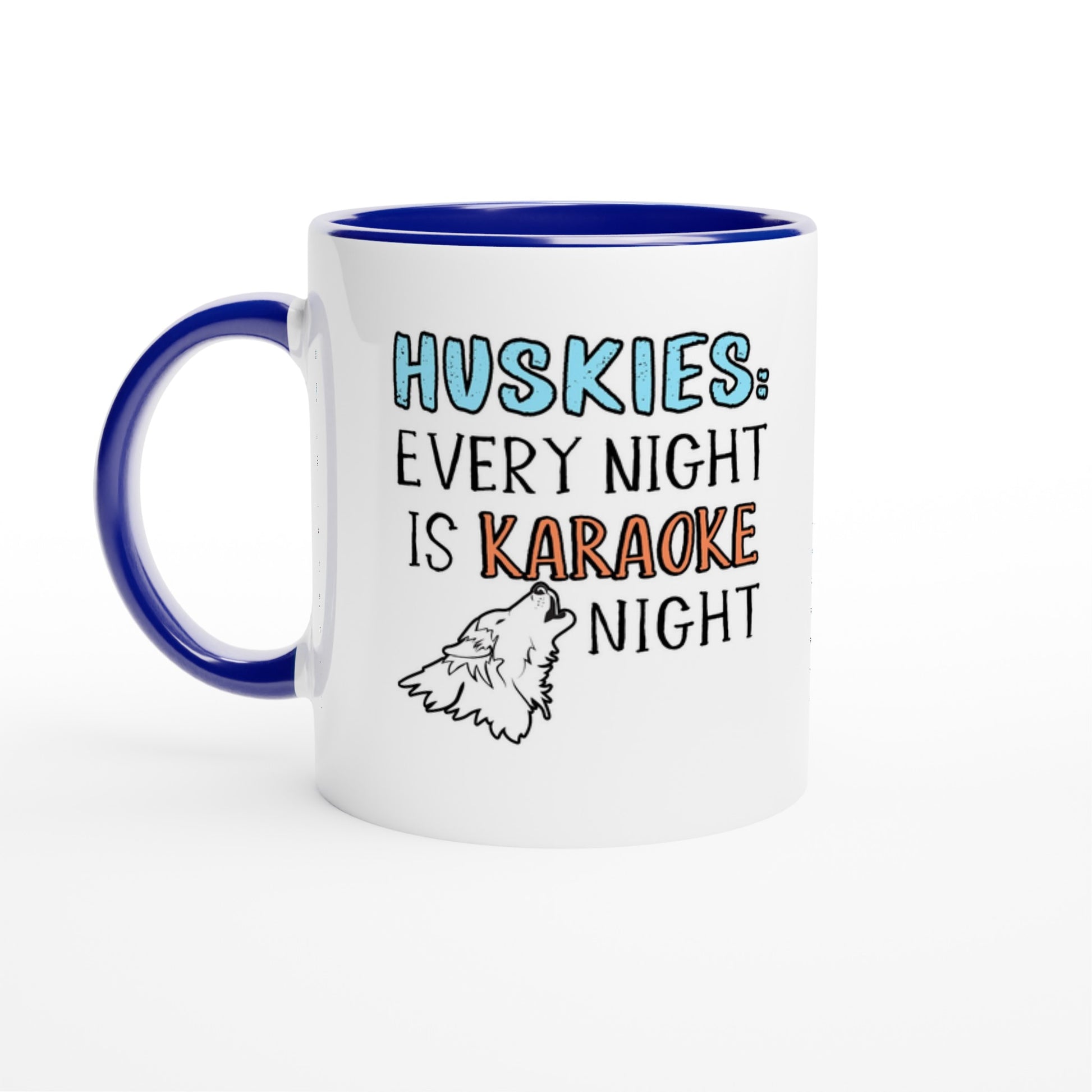 White ceramic coffee mug with the design: "HUSKIES: Every Night Is Karaoke Night.". The handle and interior are blue 