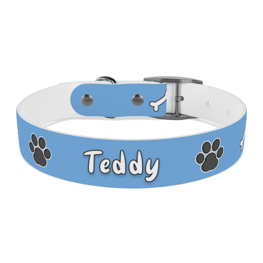 a dog collar with dog bones and paws design. The name of the dog is in the middle of the pet collar.  The dog collar color is blue