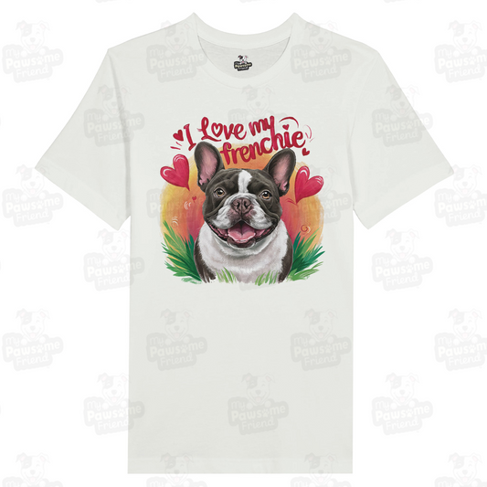 An unisex t shirt with a cute design featuring a french bulldog smiling surrounded by heart designs, and the phrase "I love my Frenchie". The color of the unisex t shirt is white