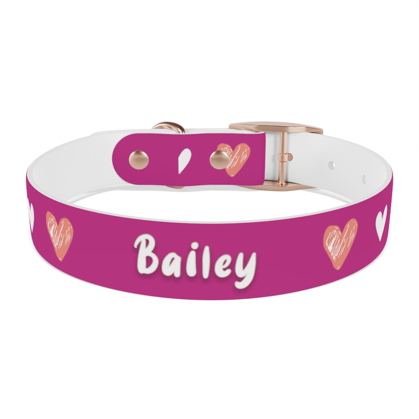a dog collar with a beautiful hearts pattern design and the dog's name in the middle of the collar. The color of the dog collar is pink
