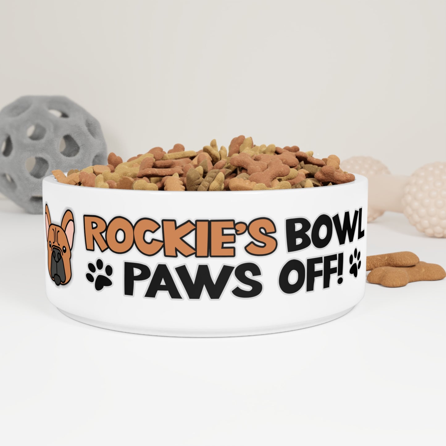 a personalized Dog Bowl with the phrase: "Rockie's Bowl Paws Off!"