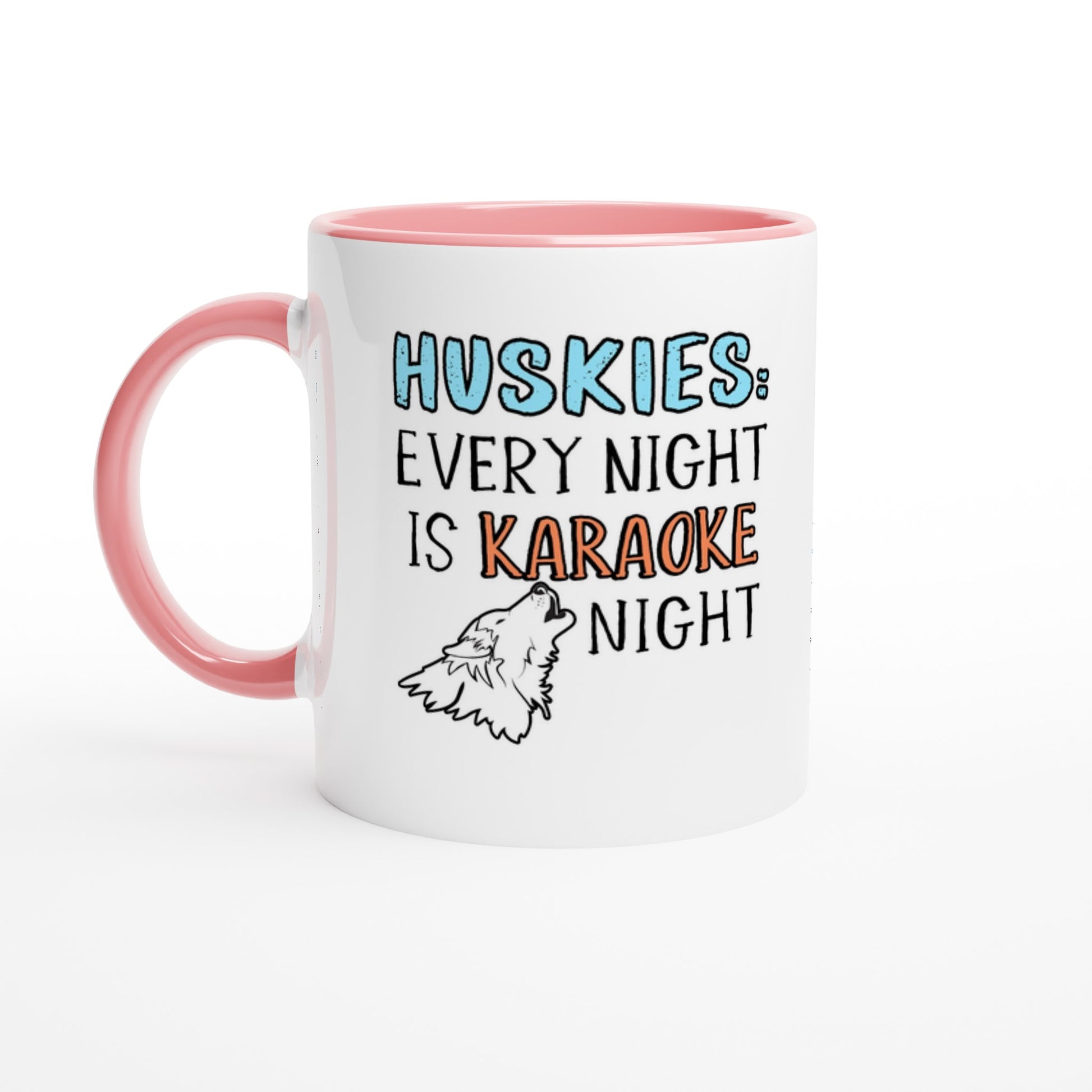 White ceramic coffee mug with the design: "HUSKIES: Every Night Is Karaoke Night.". The handle and interior are pink