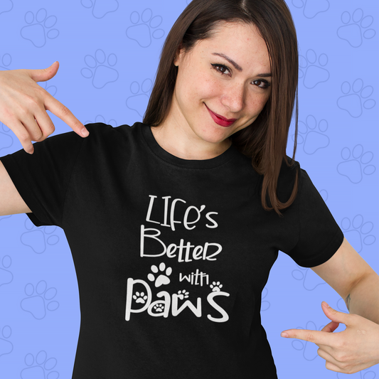 beautiful woman wearing a black t shirt with the design: "Life's better with paws". She is pointing at the t shirt